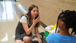  Anna Gratz signing with a student